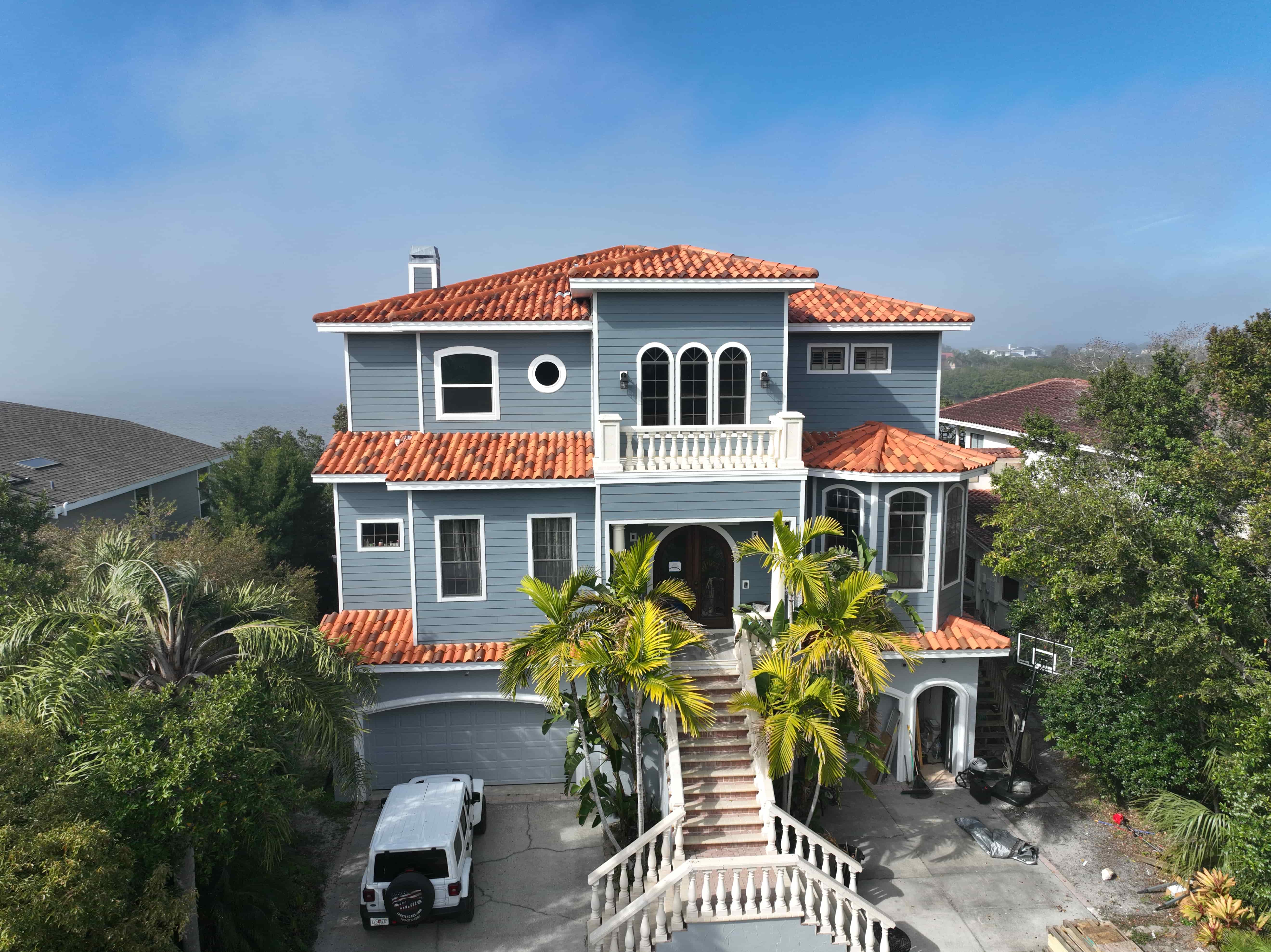 Florida home exterior transformed with Hardie siding replacing worn stucco for improved curb appeal and durability