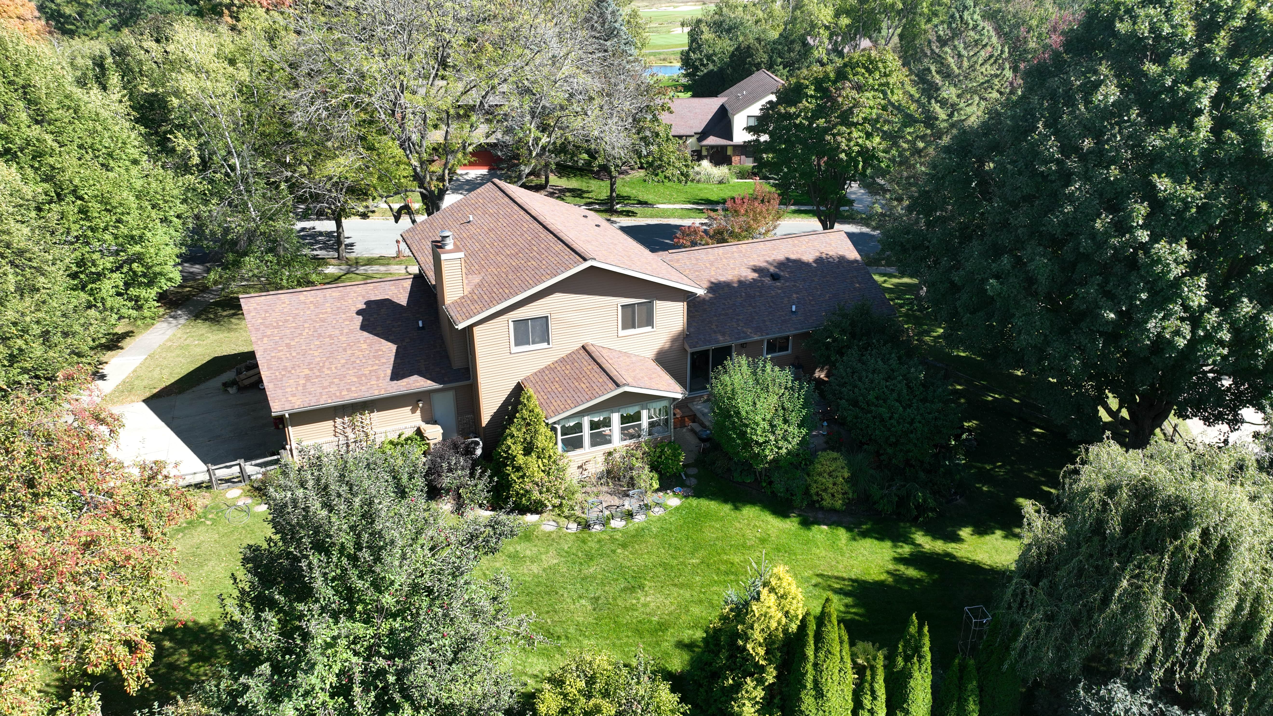 Aerial view of home with new Autumn Harvest vinyl siding showcasing updated exterior and improved curb appeal