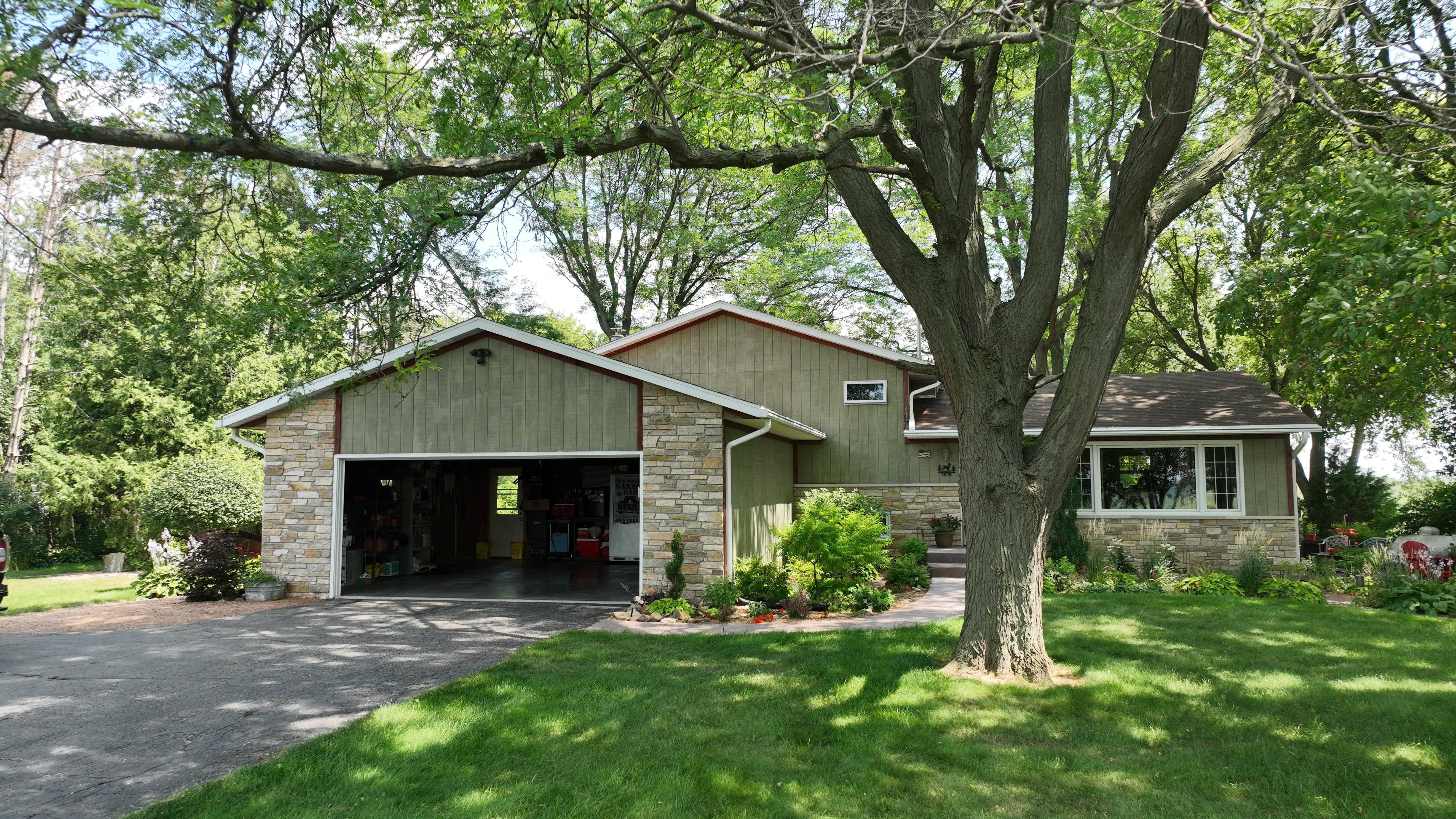 Before roof and siding replacement in Madison WI showing outdated exterior prior to color and material upgrade