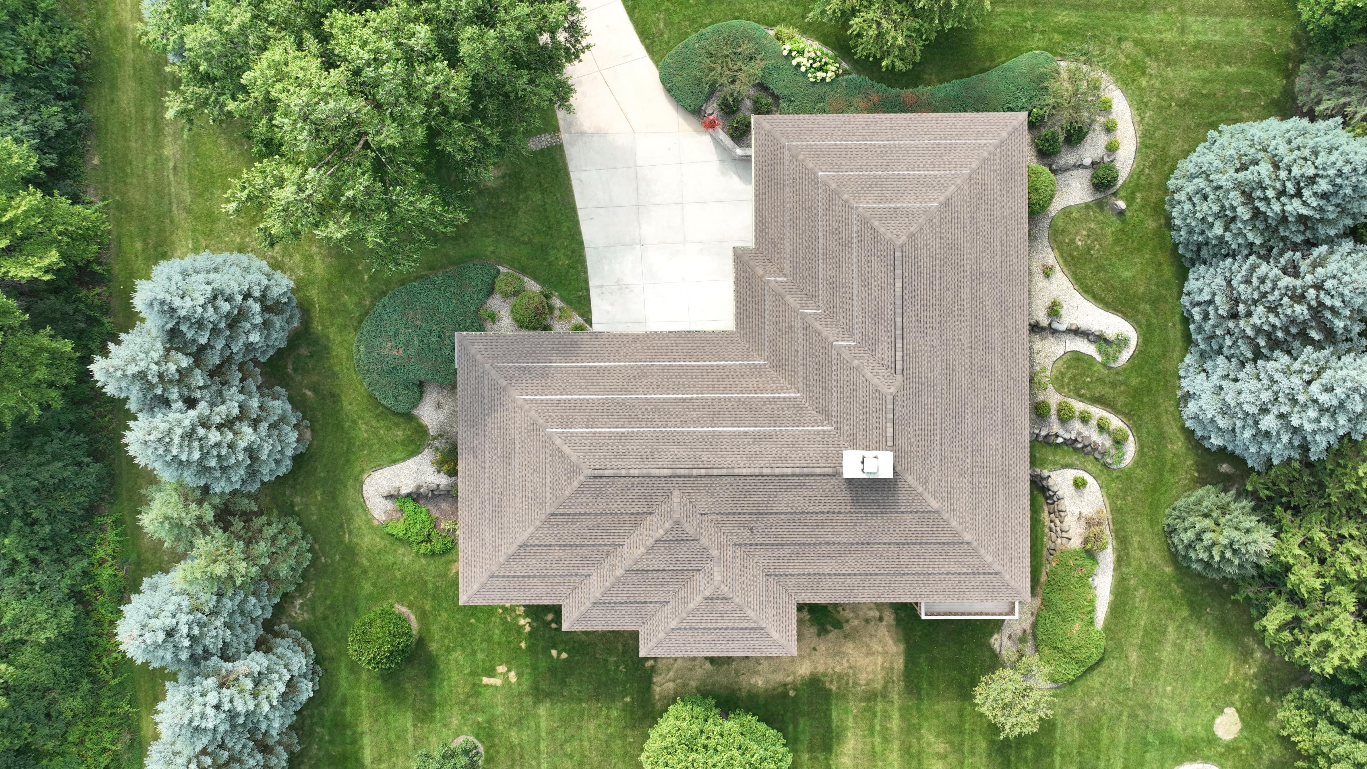 After roof replacement in Madison WI featuring new GAF Weathered Wood shingles on detailed stepped roof by Ridge Top Exteriors