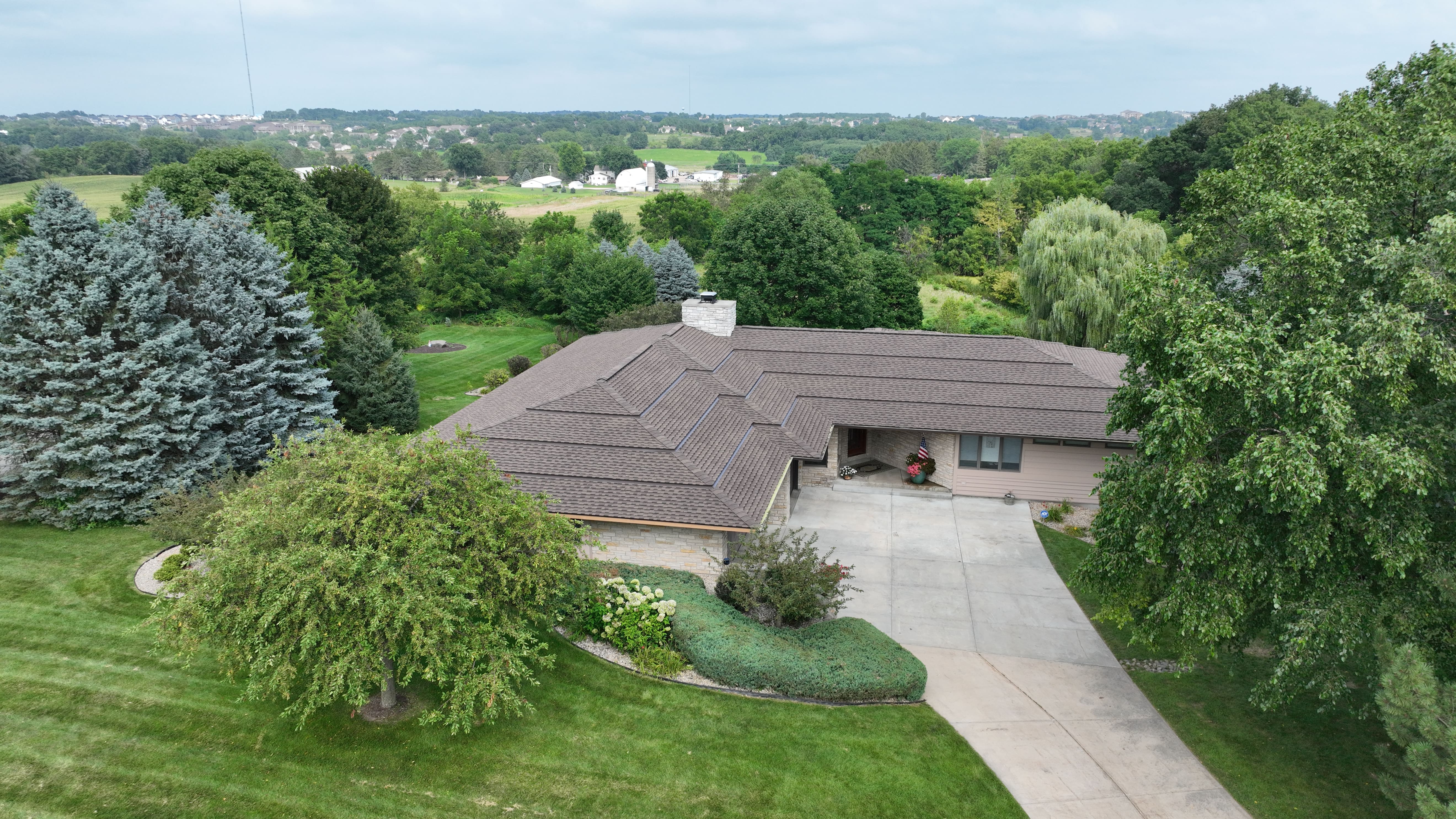 Unique stepped roof transformation in Madison WI with GAF shingles in Weathered Wood installed by Ridge Top Exteriors