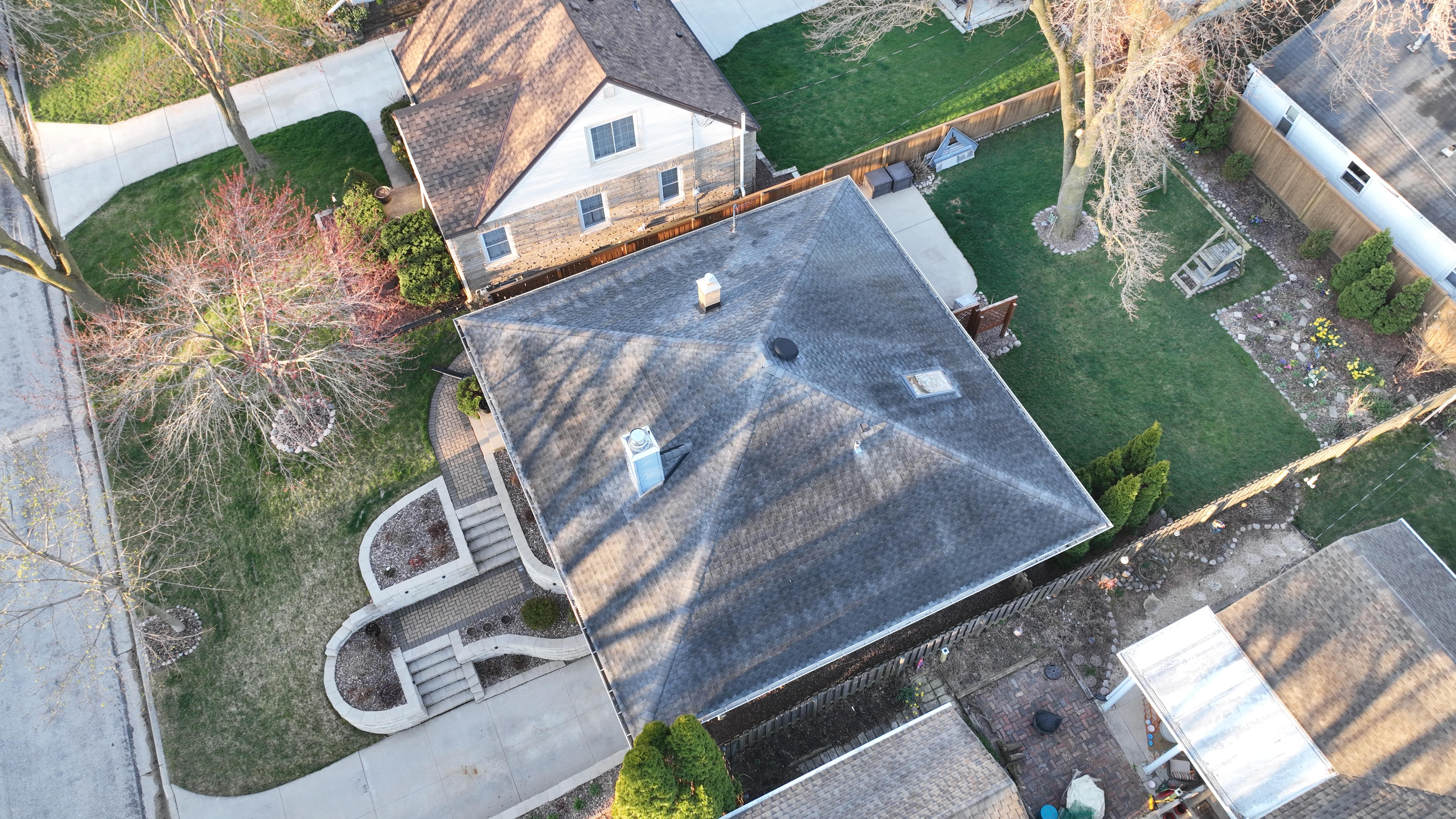Before roof replacement in Milwaukee showing leaking and damaged asphalt shingles prior to warranty-covered installation