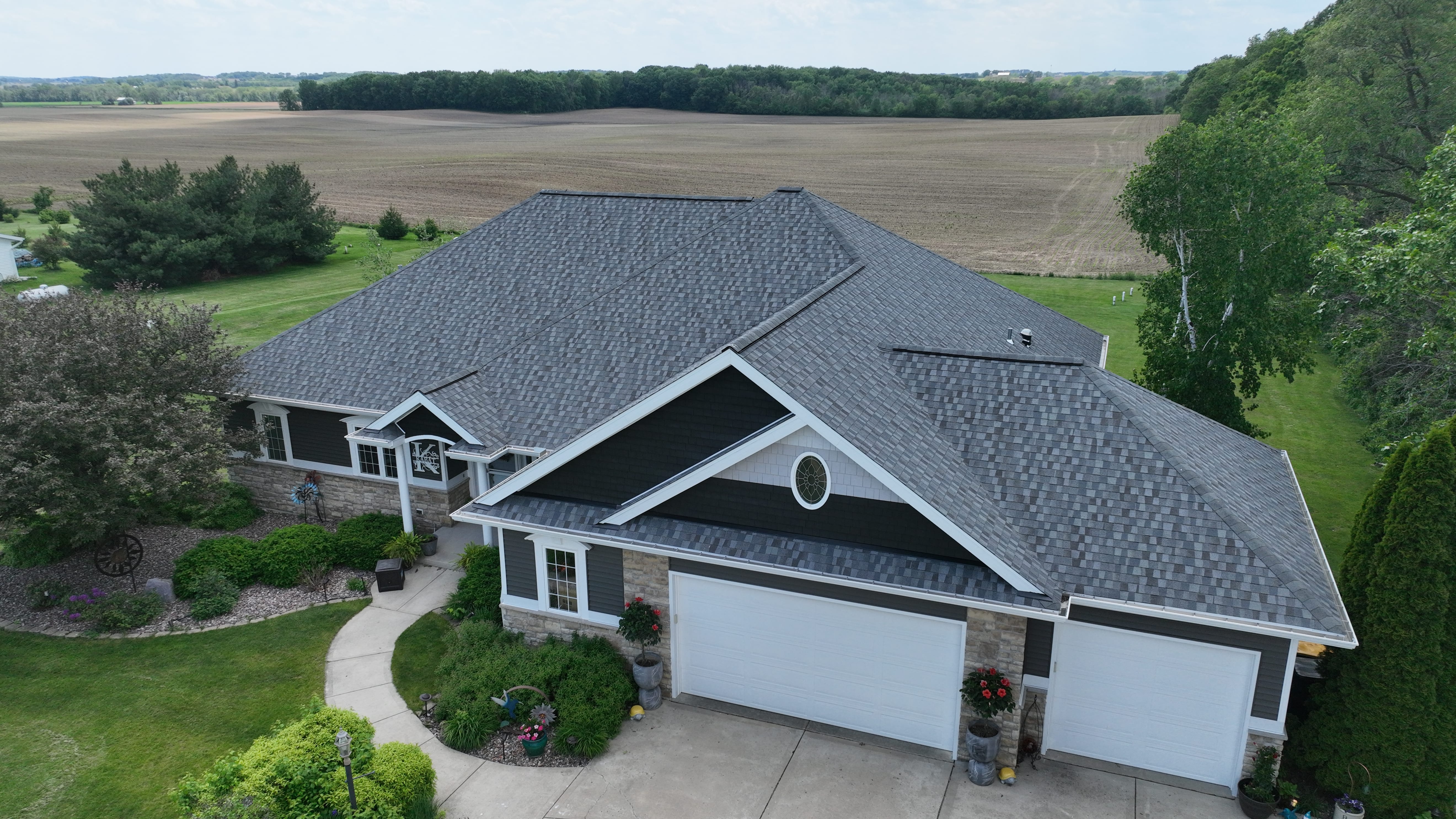 Madison WI roofing, siding, and gutters transformation by Ridge Top Exteriors featuring GAF Timberline HDZ shingles and Mastic vinyl siding