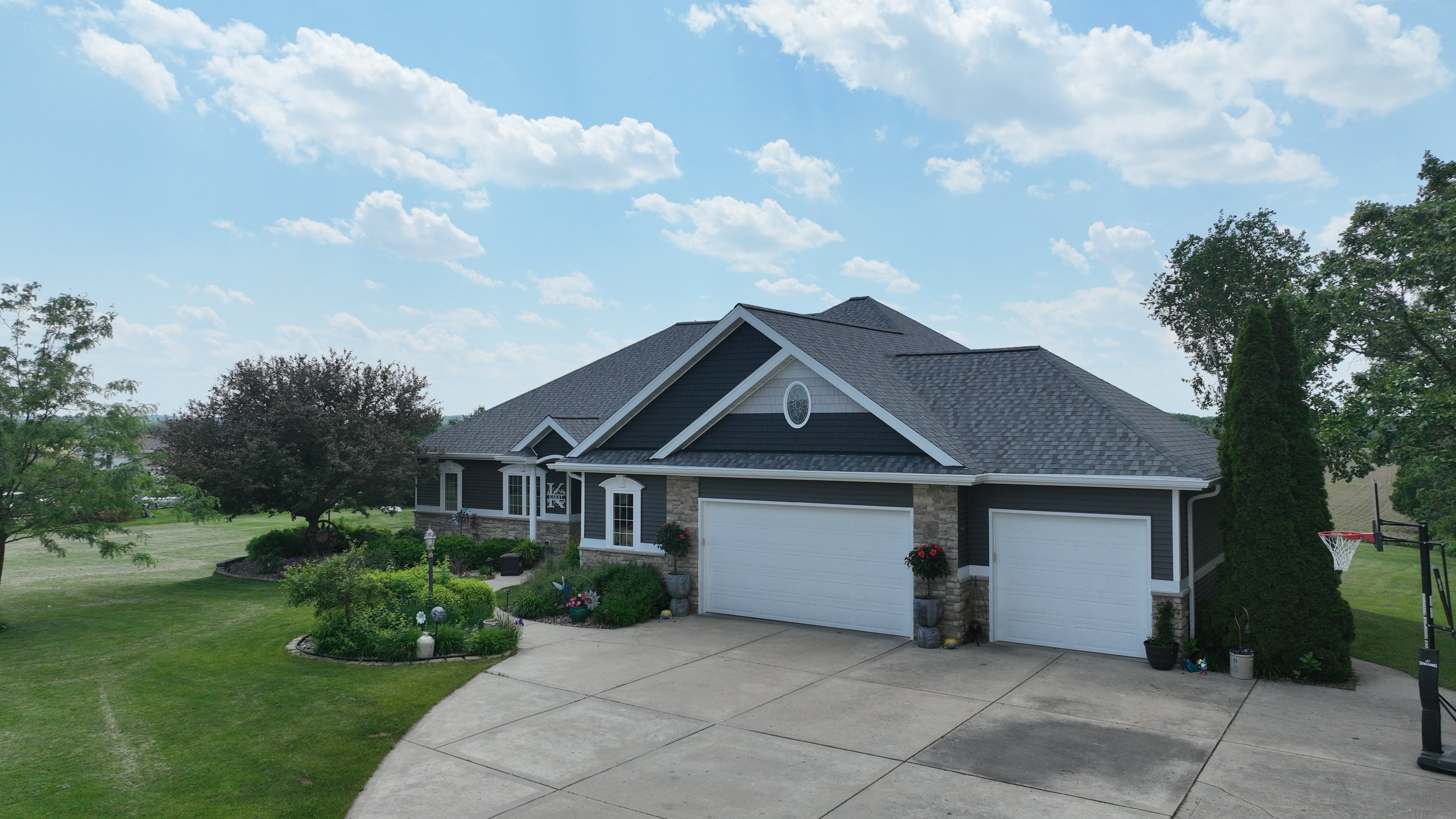 After exterior transformation in Madison WI with new GAF Timberline HDZ roof, Mastic vinyl siding, and seamless gutters by Ridge Top Exteriors