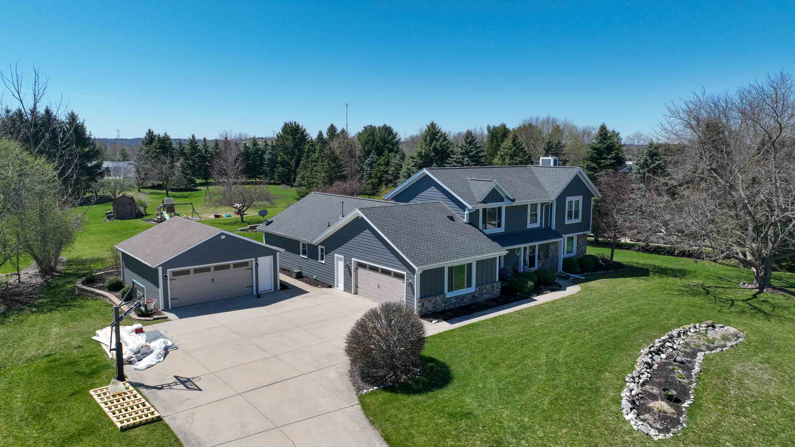 Milwaukee roofing and siding transformation by Ridge Top Exteriors featuring GAF asphalt shingles and LP SmartSide siding in Cavern Steel