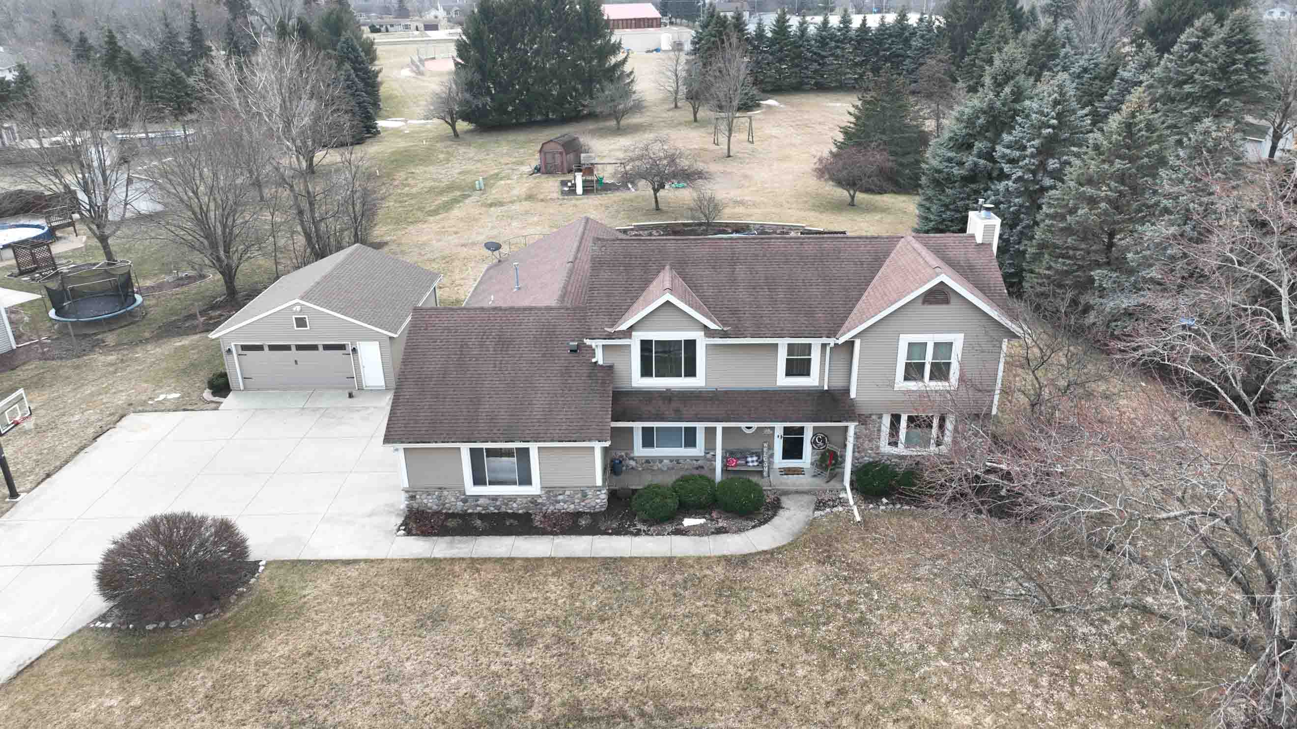 Before exterior renovation in Milwaukee showing older siding and roof prior to LP SmartSide siding and asphalt shingle replacement