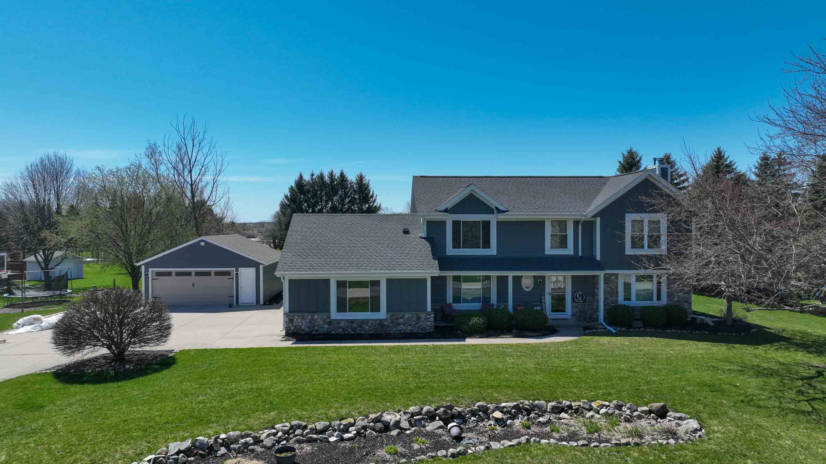 After exterior transformation in Milwaukee with new GAF asphalt shingle roof and LP SmartSide siding in Cavern Steel by Ridge Top Exteriors
