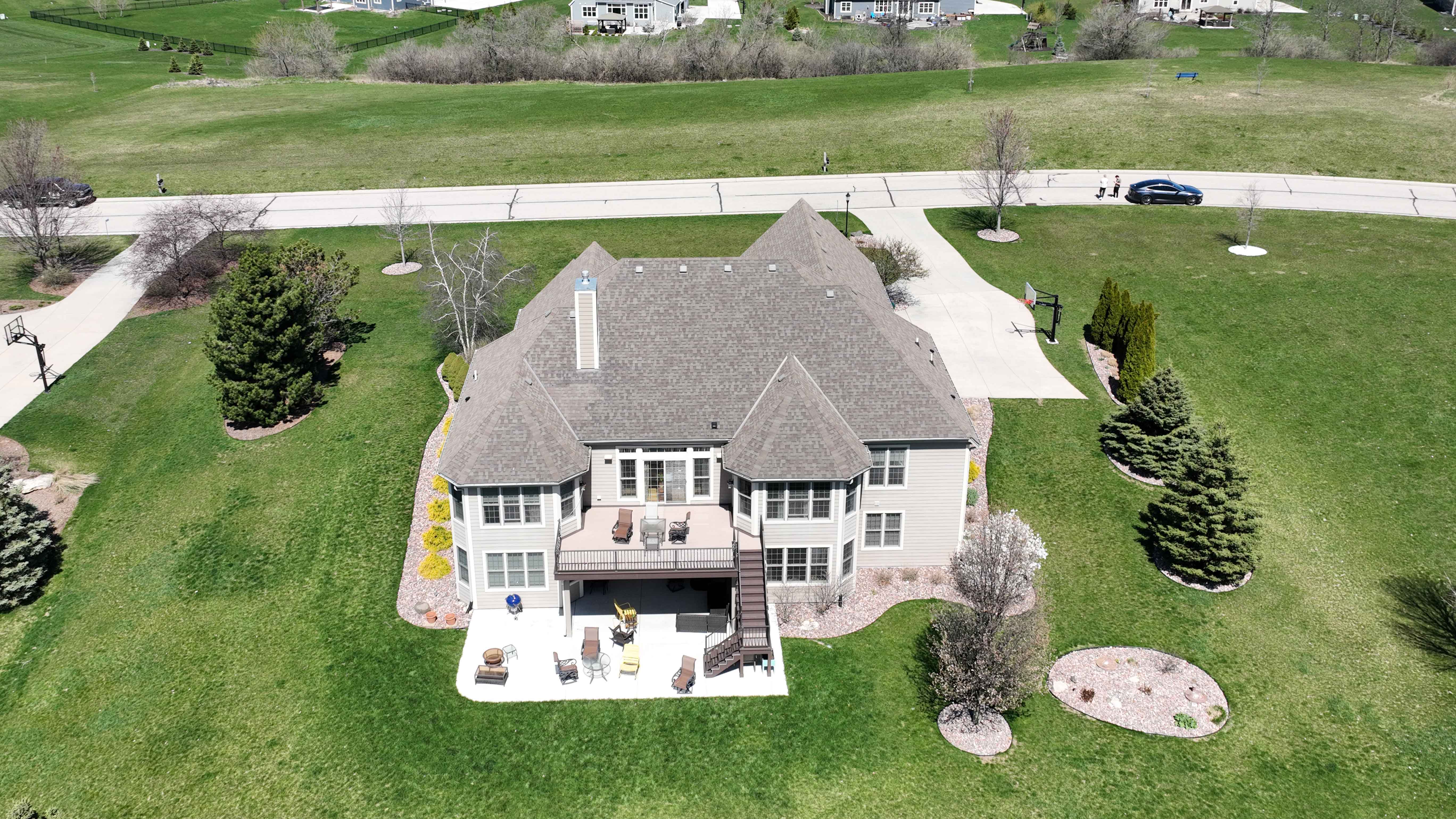 Before roof replacement in Milwaukee showing worn and weathered shingles with visible aging and discoloration