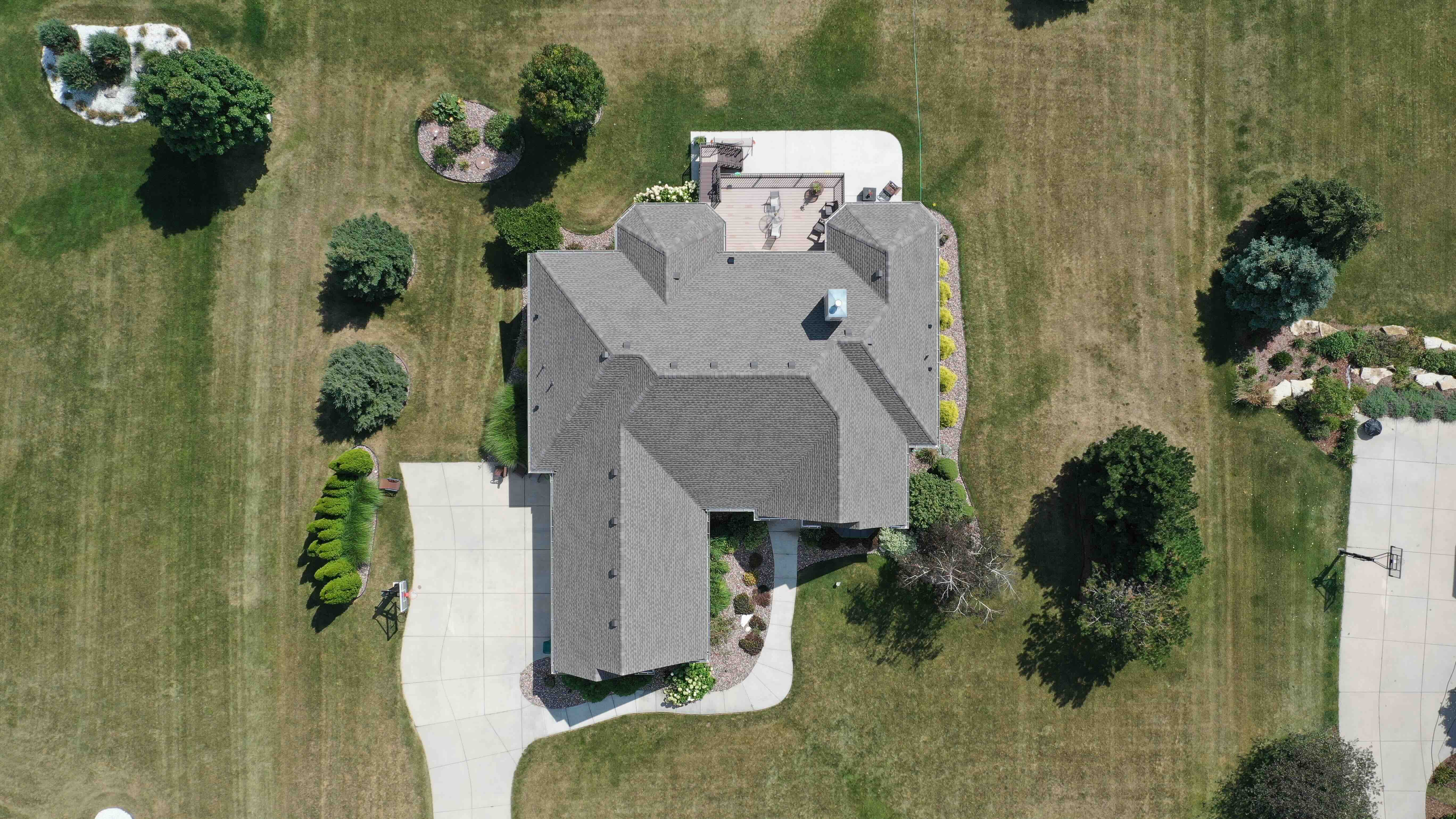 Aerial top view of new asphalt shingle roof installation in Milwaukee showing precise layout and ridge vent system by Ridge Top Exteriors